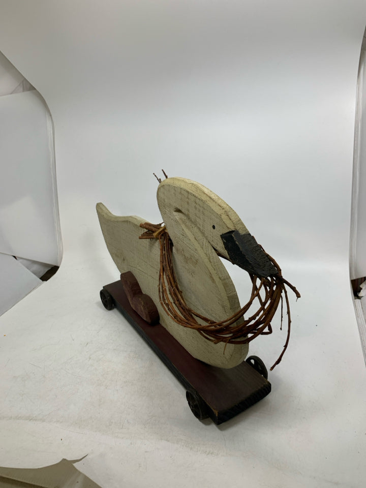 LARGE WOOD GOOSE ON WHEELS W/ TWIG GARLAND AROUND NECK.