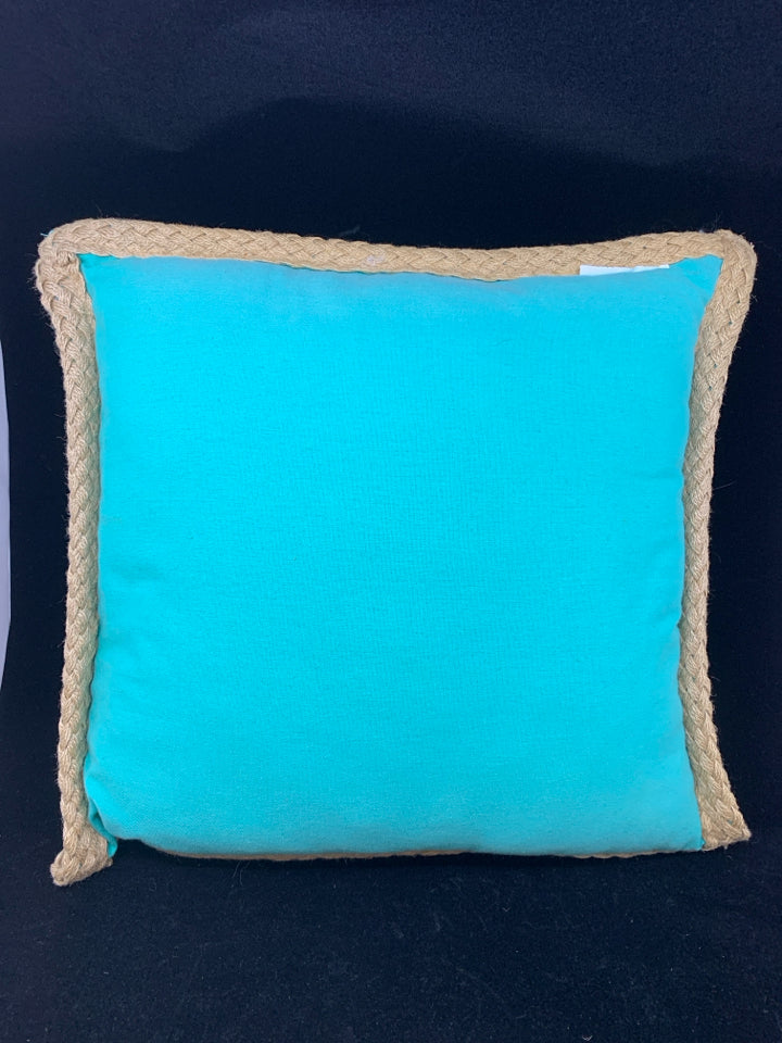 TEAL PILLOW W/WHITE DESIGN & BRAIDED BURLAP BORDER.