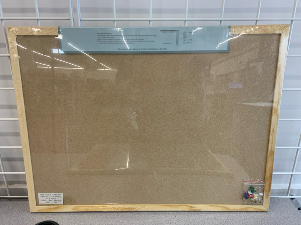 NIP FRAMED CORKBOARD.