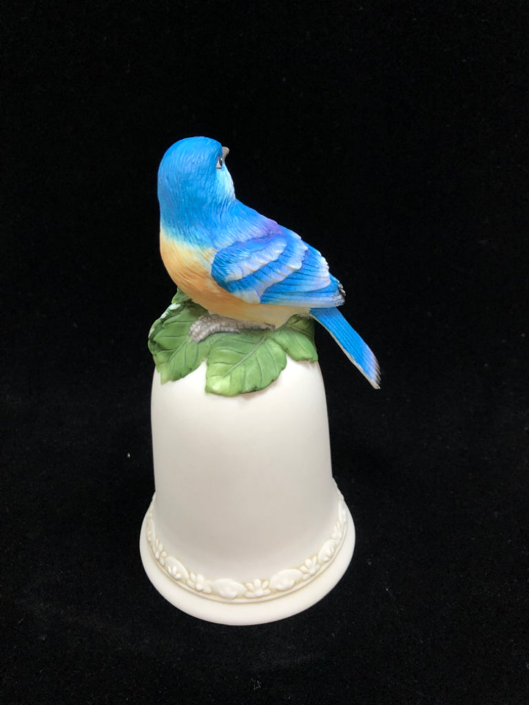 PORCELAIN BLUE BIRD ON FLORAL BELL FIGURINE.