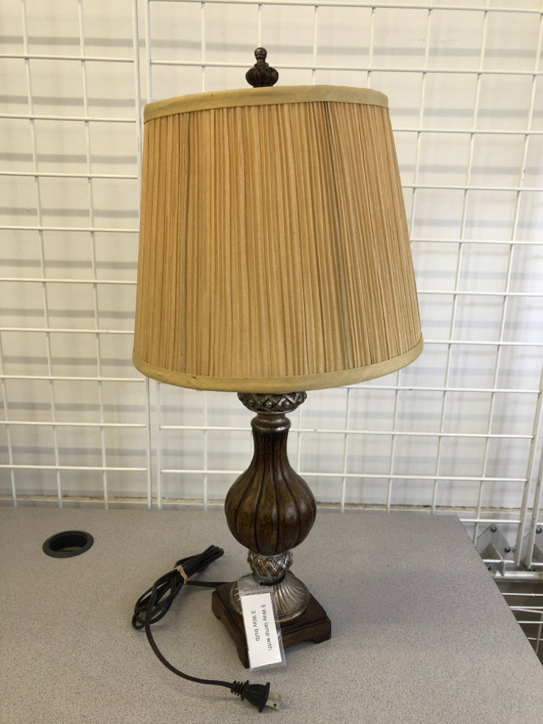 BRONZE PAINTED BASE 3WAY LAMP W/RIBBED TAN SHADE.