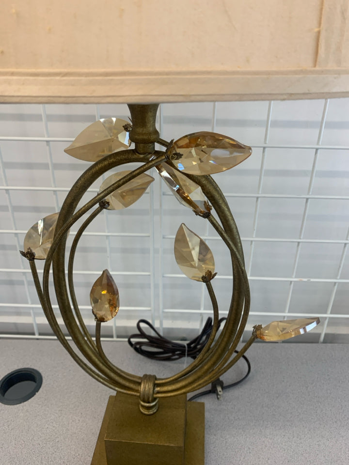 GOLD BASE LAMP W/CRYSTAL LEAVES AND CREAM SHADE.