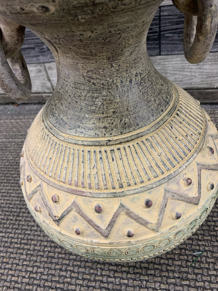 ORANGE AND YELLOW FLORAL IN CARVED POTTERY VASE.