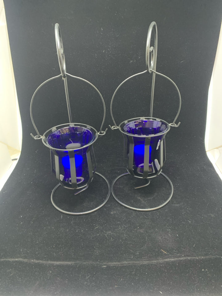2 HANGING BLUE GLASS CANDLE HOLDERS.