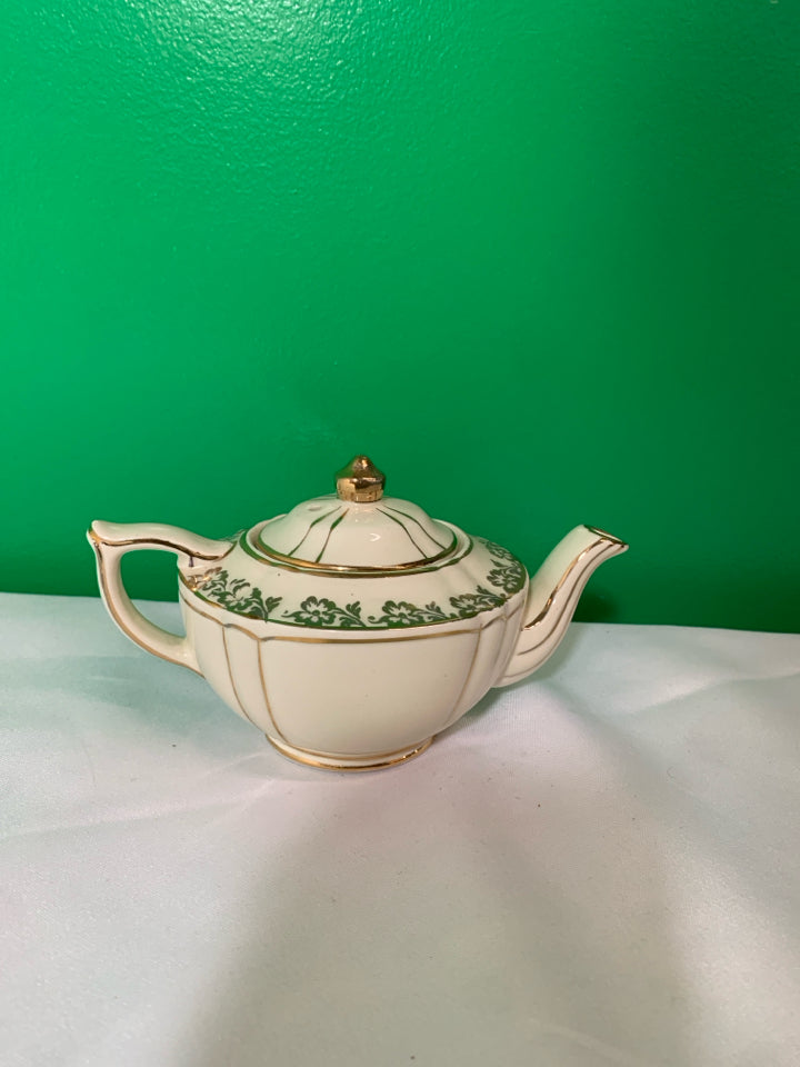 VTG CREAM AND GOLD TEAPOT.