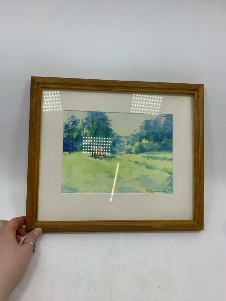 WATERCOLOR FIELD W/HORSE DRAWN CARRIAGE IN WOOD FRAME.