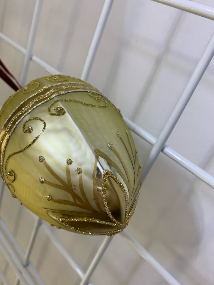 GOLD PINECONE GLASS ORNAMENT.