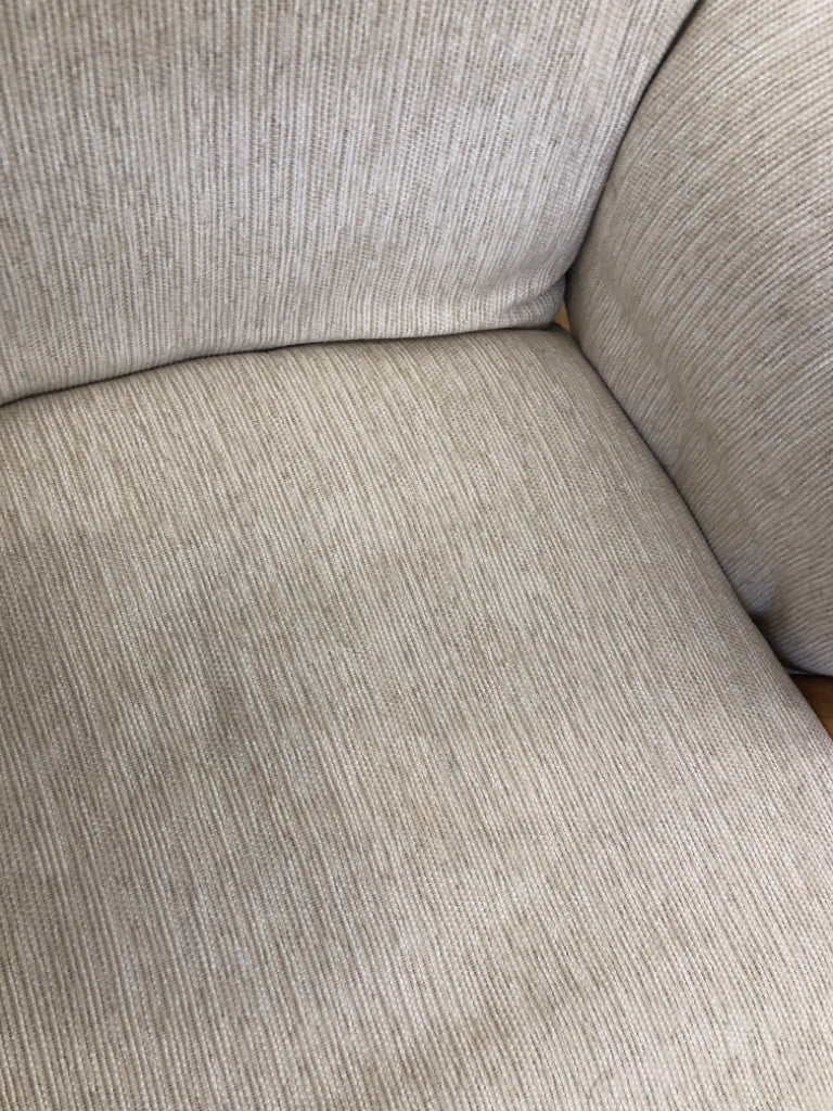 BLONDE WOODEN ROCKING CHAIR W/LEVER TO LOCK & BEIGE CUSHION.