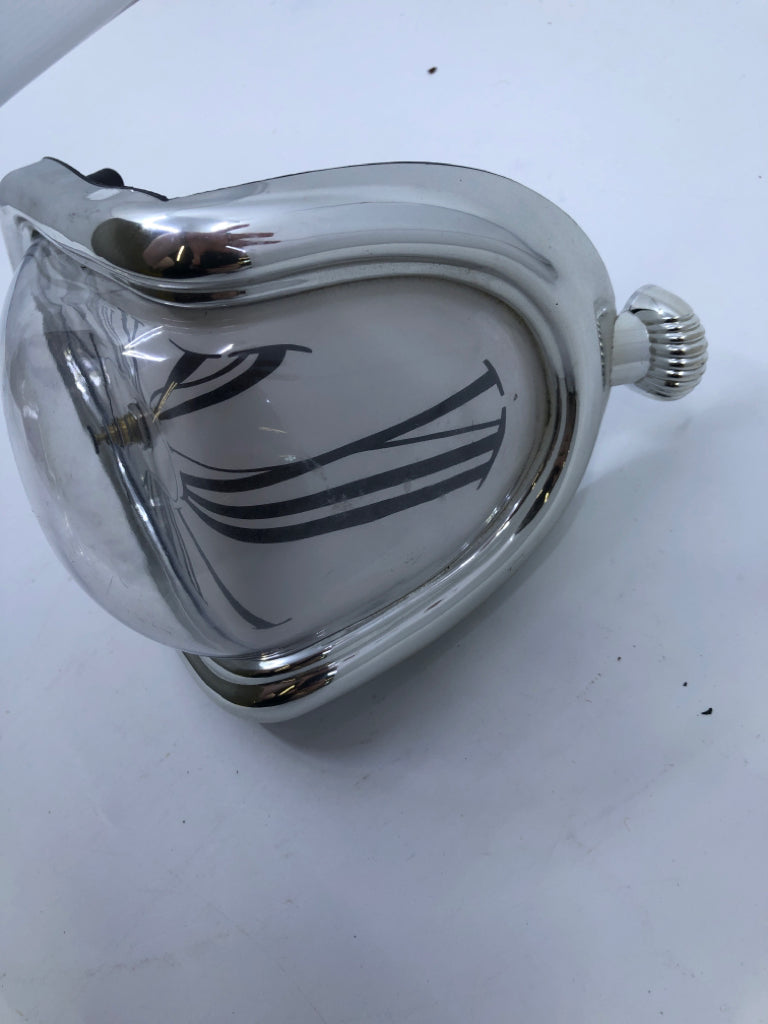 SILVER MELTING SHELF CLOCK.