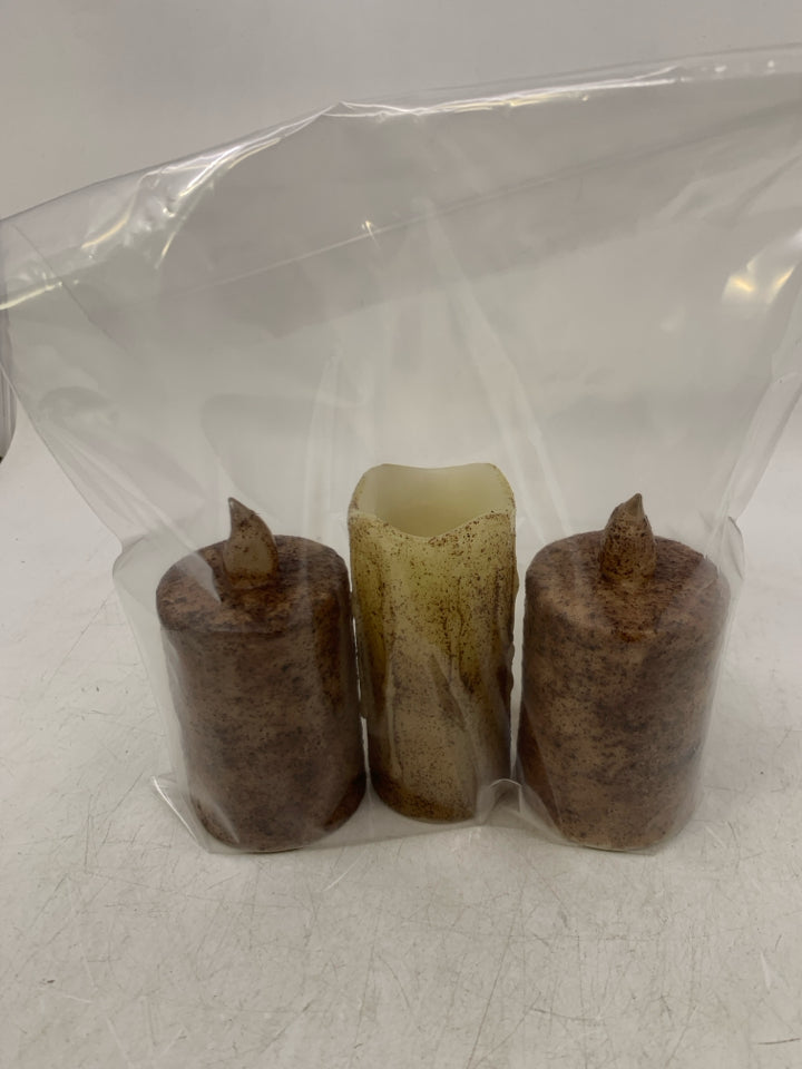 3 BATTERY POWERED FAUX CANDLES IN BAG.
