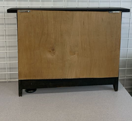 DISTRESSED BLACK WALL SHELF W/ PEG HOOKS.