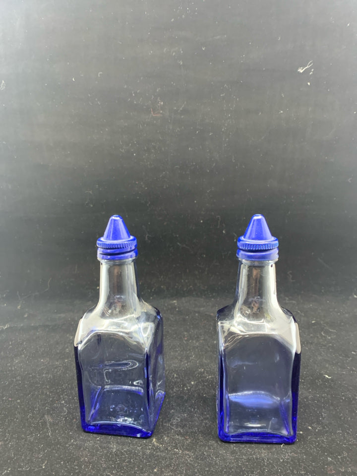 BLUE SQUARE GLASS OIL AND VINEGAR BOTTLES .