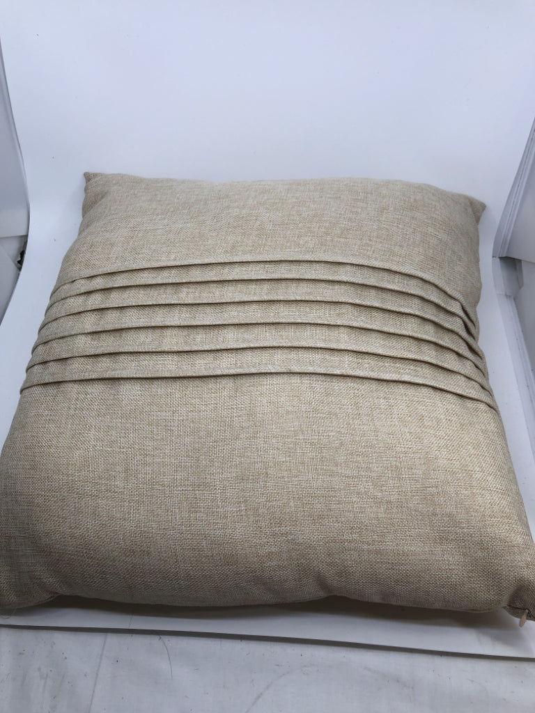 BEIGE PILLOW W/ PLEATS IN MIDDLE.