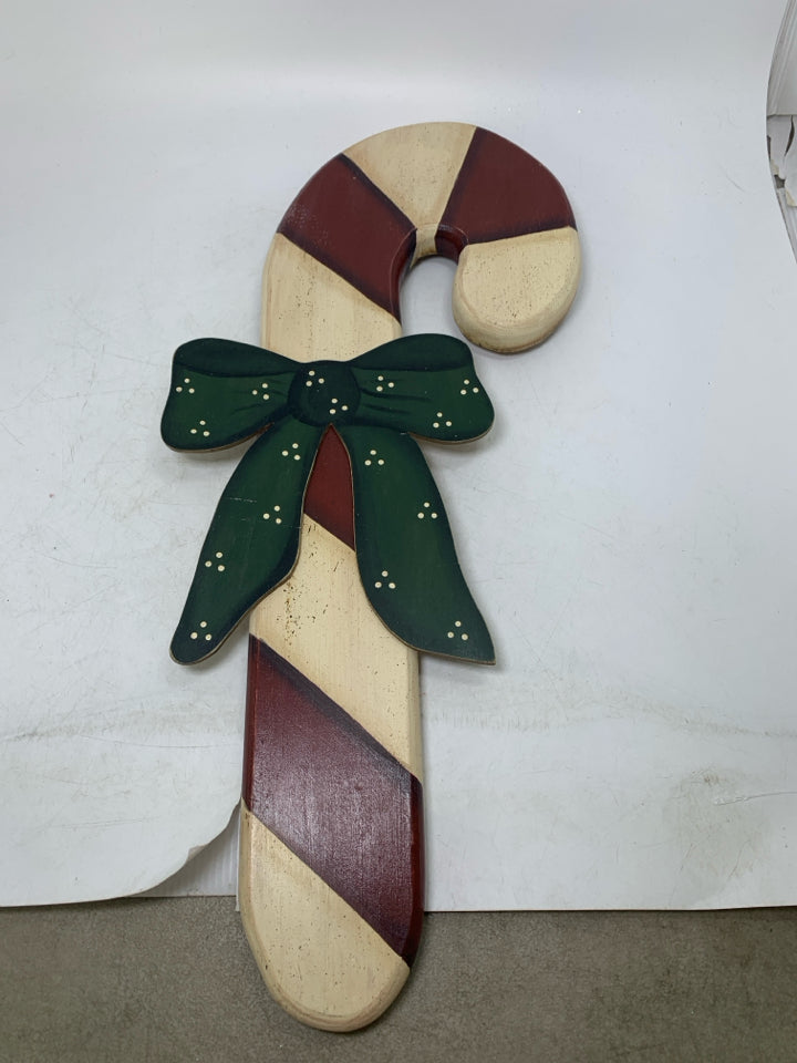 PRIMITIVE STYLE CANDY CANE W/ RED BOW WALL HANGING.