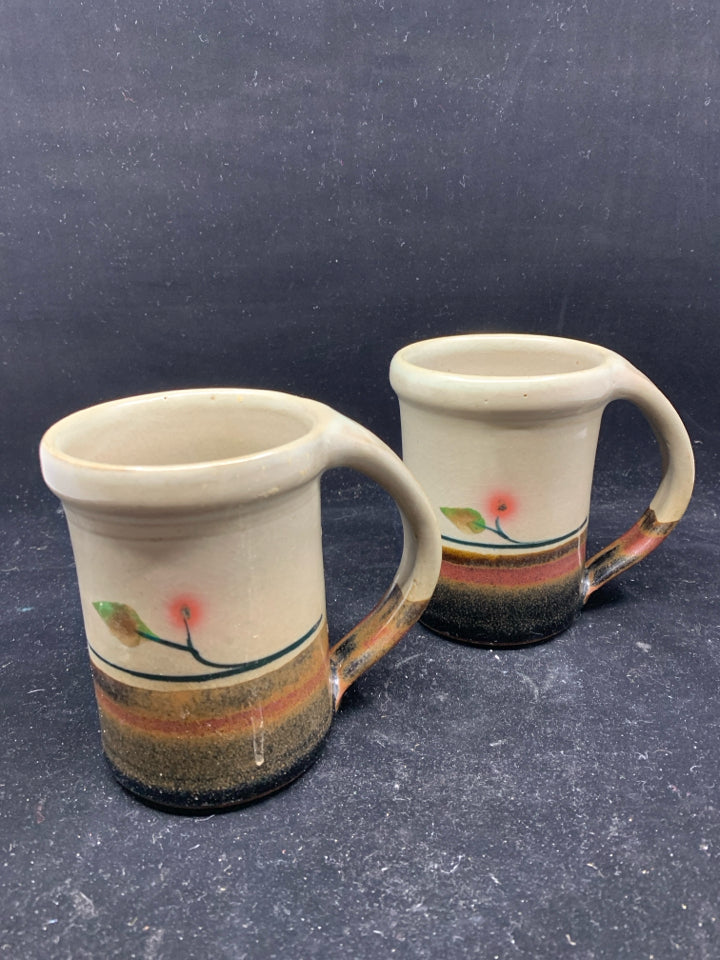 2 POTTERY MUGS W/ GRAY,DARK BROWN, RED BOTTOM W/ LEAF.