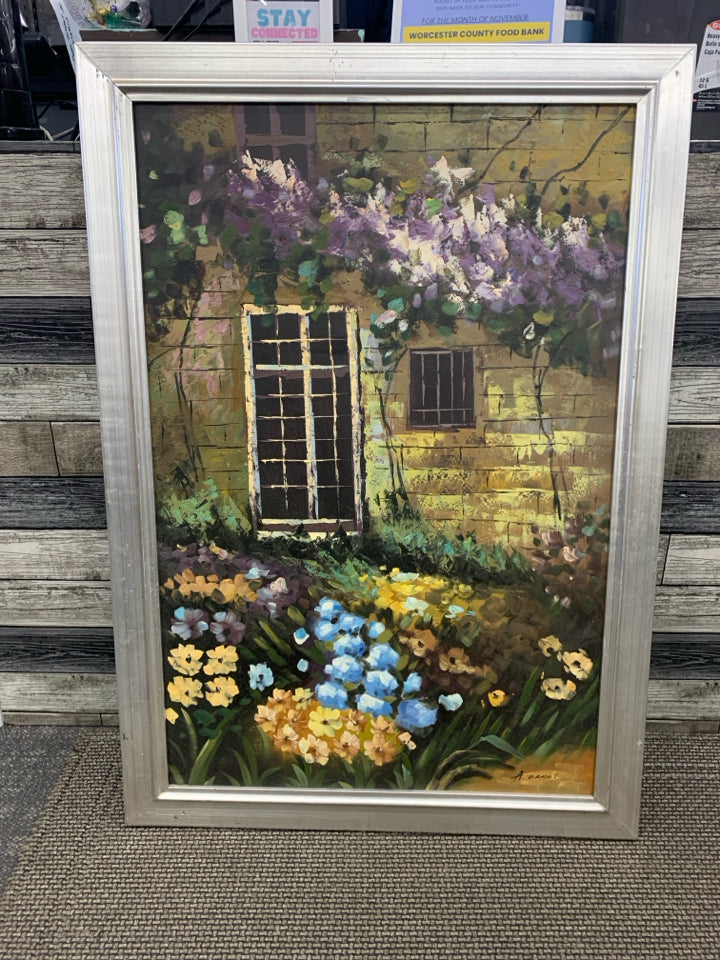 LARGE FLOWER GARDEN IN FRONT OF BUILDING PRINT IN SILVER FRAME.