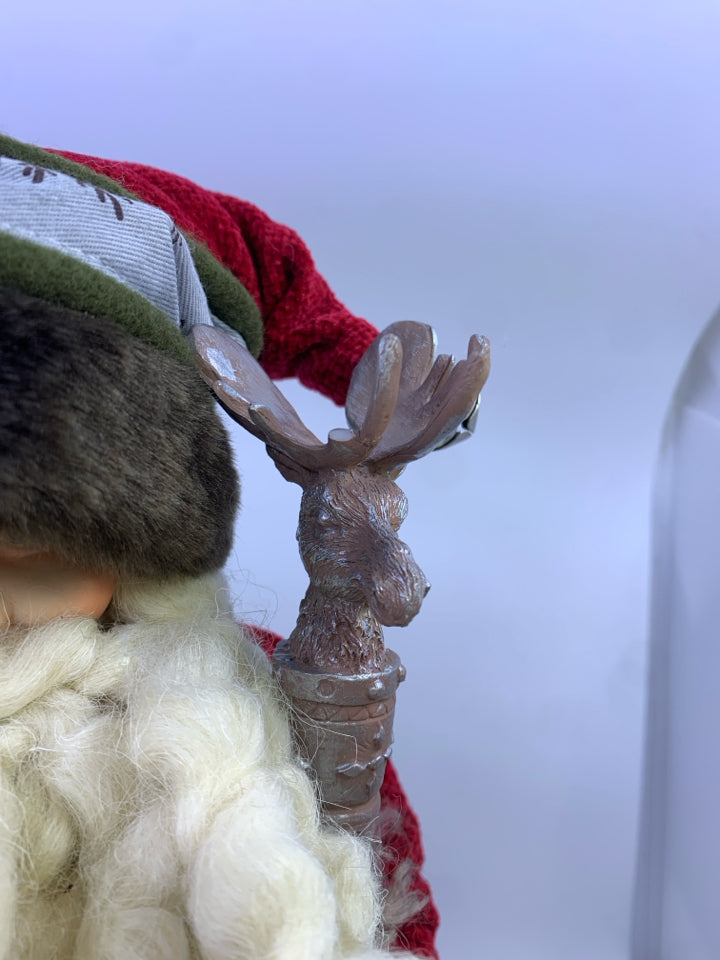 GREEN SANTA WITH DEER POLE HOLDING SACK.