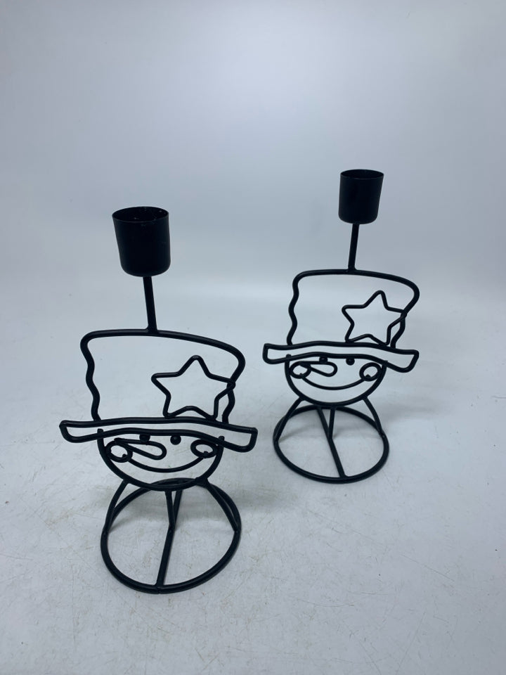 2 BLACK METAL SNOWMAN FACES W/ HATS TAPERED CANDLE HODLERS.