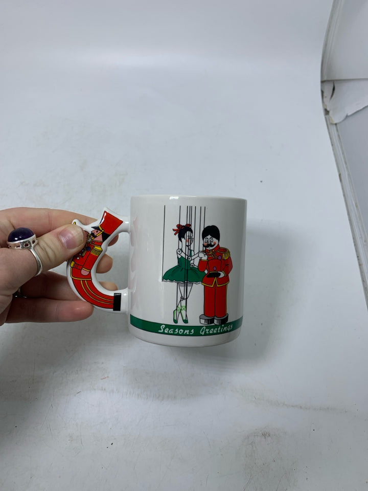 WHITE MUG W/ NUTCRACKER HANDLE "SEASON GREETINGS".