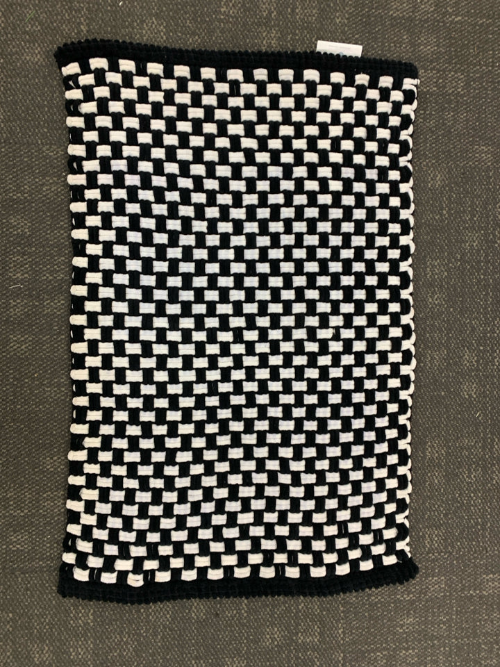B&W CHECKERED RUG.