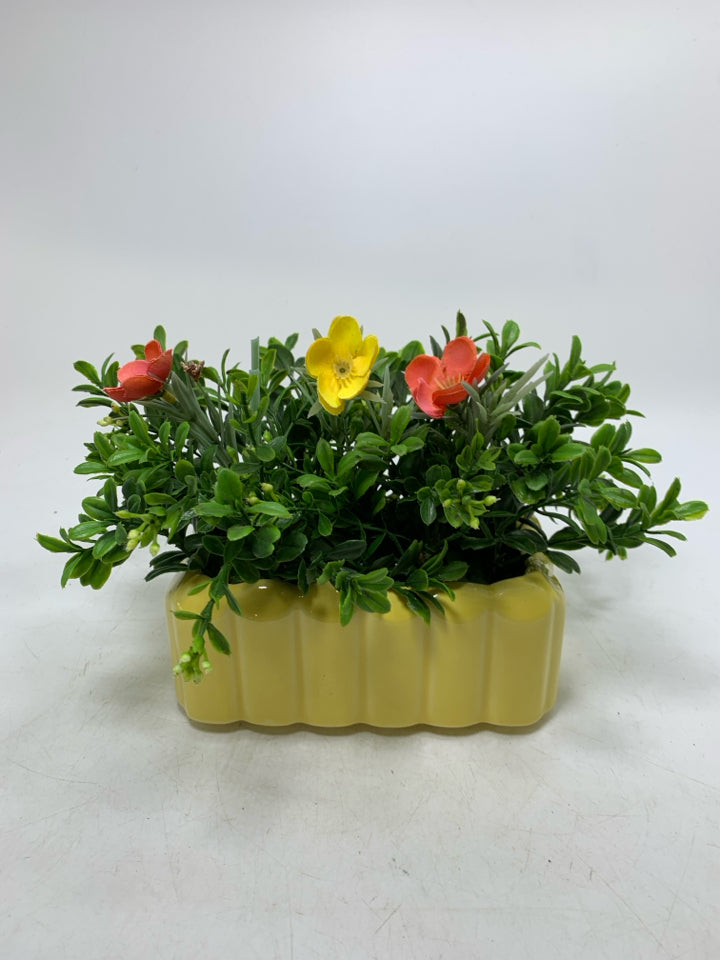 YELLOW PLANTER W/ FAUX FLOWERS.