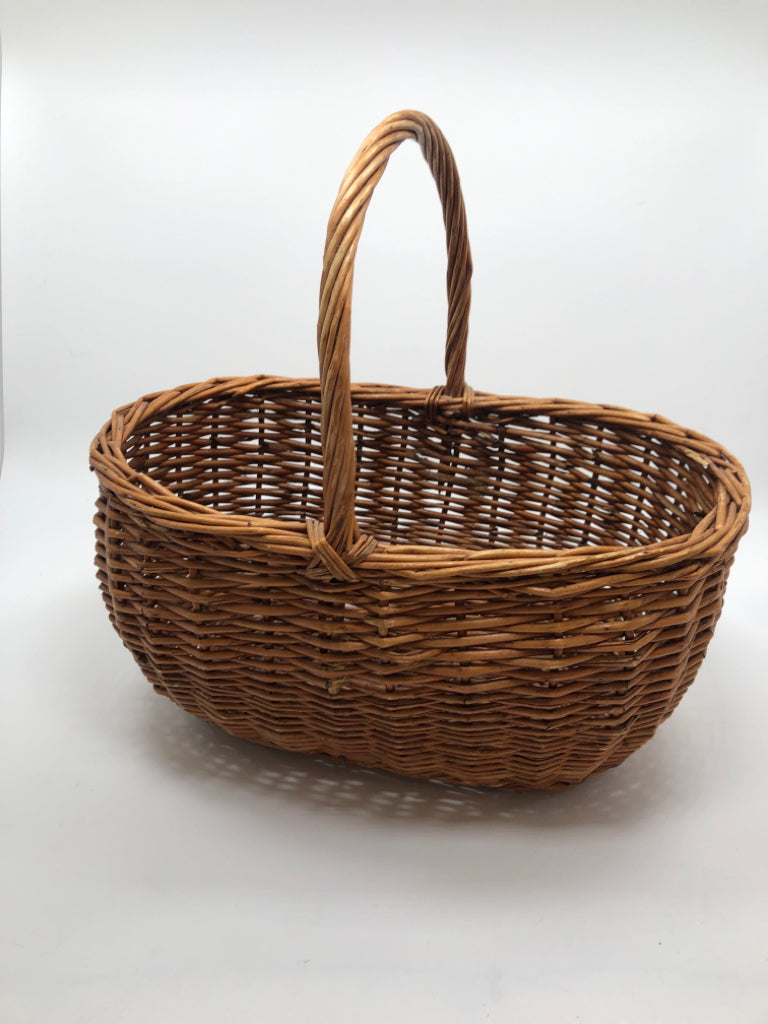 BROWN OVAL WICKER BASKET.