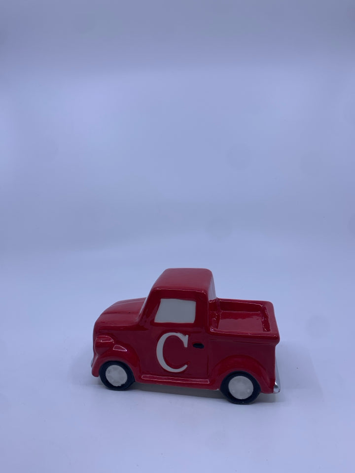 SMALL CERAMIC RED TRUCK W/ "C" ON IT.