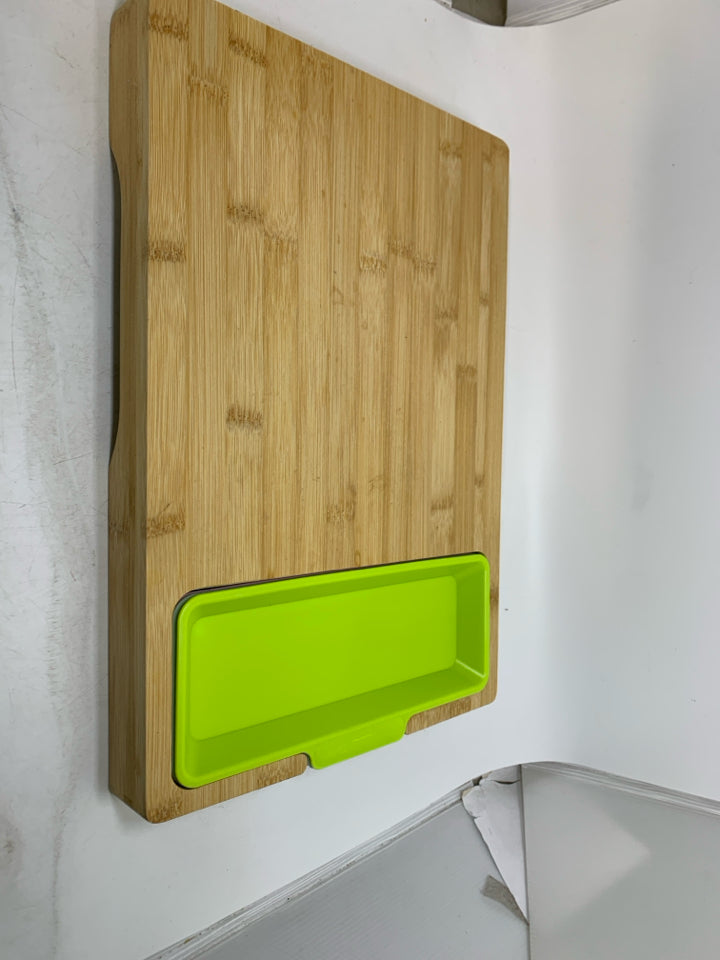 WOOD CUTTING BOARD W/ PLASTIC INSERTS.