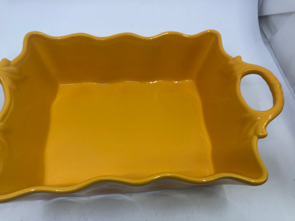 MUSTARD YELLOW RUFFLED EDGE BAKING DISH W HANDLES.
