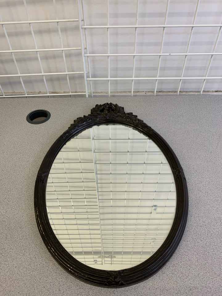 VTG OVAL MIRROR W/BROWN BORDER & FLORAL DECOR ON TOP WALL HANGING.