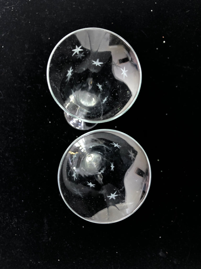 2 GLASS CHAMPAGNE FLUTES W/ ETCHED STARS.
