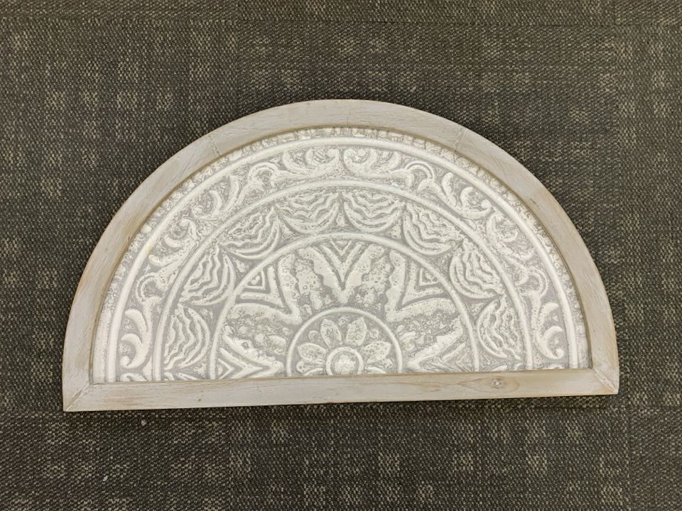 DISTRESSED HALF-CIRCLE METAL MEDALLION.