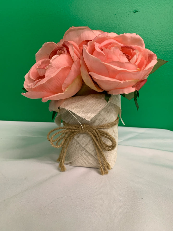 FAUX PINK FLORAL IN BURLAP PLANTER.