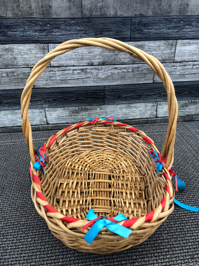 BLONDE WICKER BASKET W/BLUE AND RED BOWS.