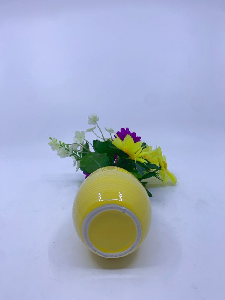 YELLOW AND PURPLE FAUX FLORAL IN YELLOW VASE.