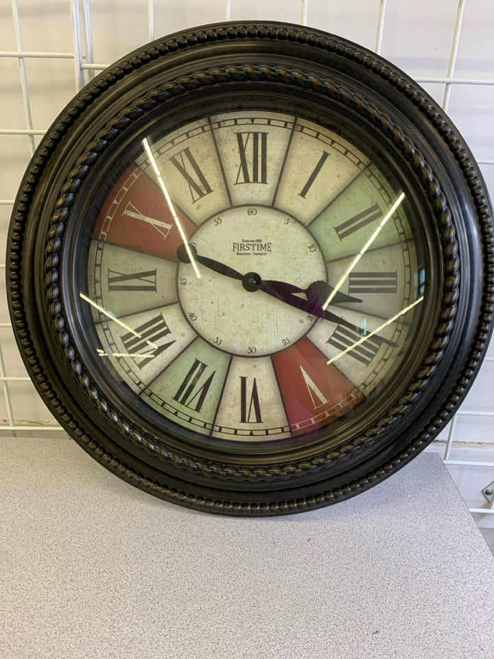BROWN PLASTIC CLOCK W/ COLOR BLOCK FACE.