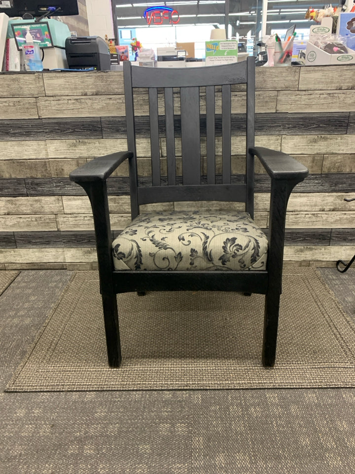 BLACK WOOD CHAIR W/ GREY BLACK LEAF DESIGN CUSHION.