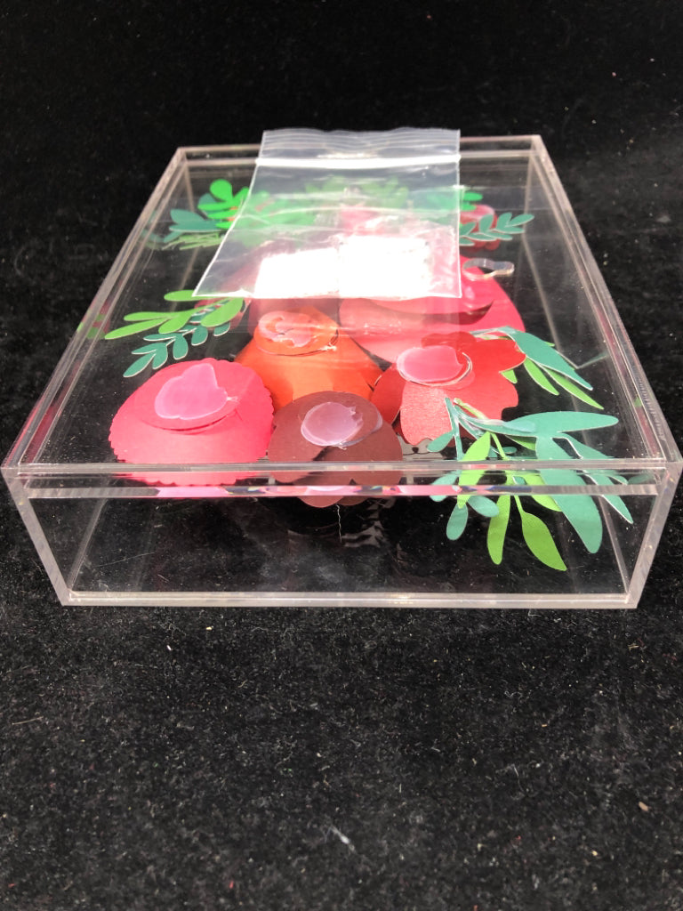 CLEAR PLASTIC SHADOW W/ ROLLING PAPER FLOWERS MERRY CHRISTMAS.
