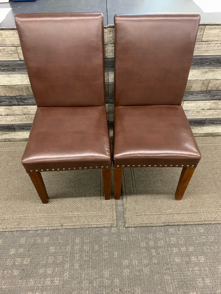 2 BROWN FAUX LEATHER CHAIRS W/ STUDDED EDGE.