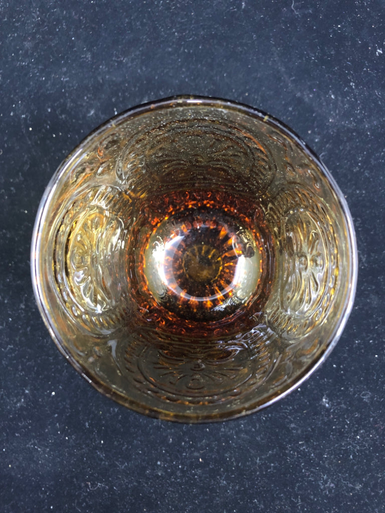 AMBER GLASS EMBOSSED TEALIGHT HOLDER.