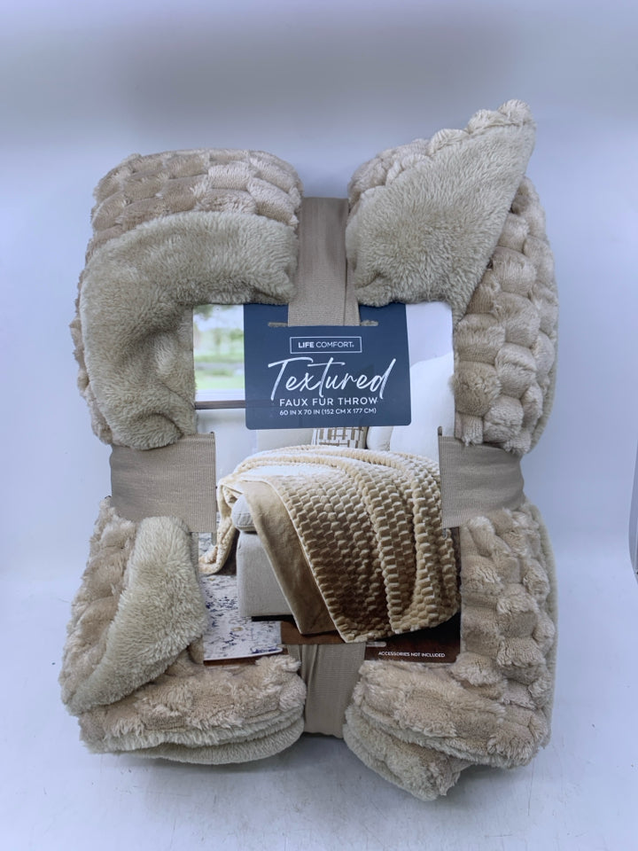 NIP TAN FAUX FUR THROW.