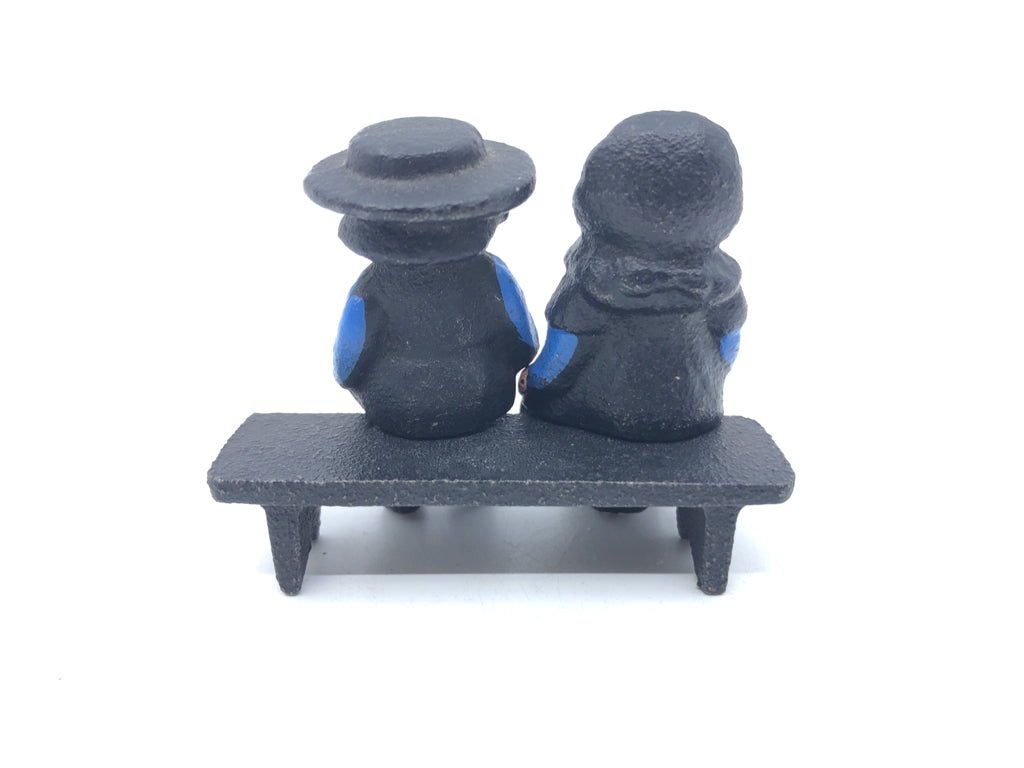 3PC CAST IRON AMISH COUPLE SITTING ON BENCH.