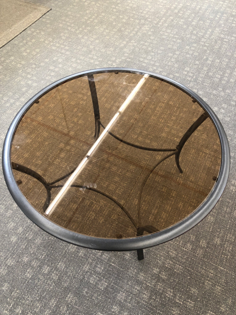 ROUND BLACK METAL COFFEE TABLE W/BROWN GLASS TOP.