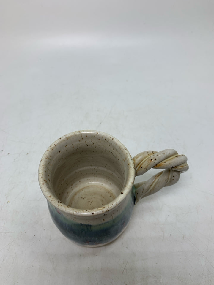 WHITE SPECKLED POTTERY MUG W/ TWISTED HANDLE BLUE DRIPS.