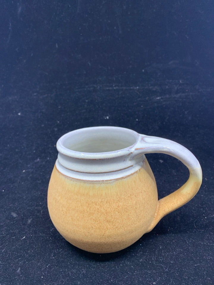 SMALL TAN POTTERY MUG.