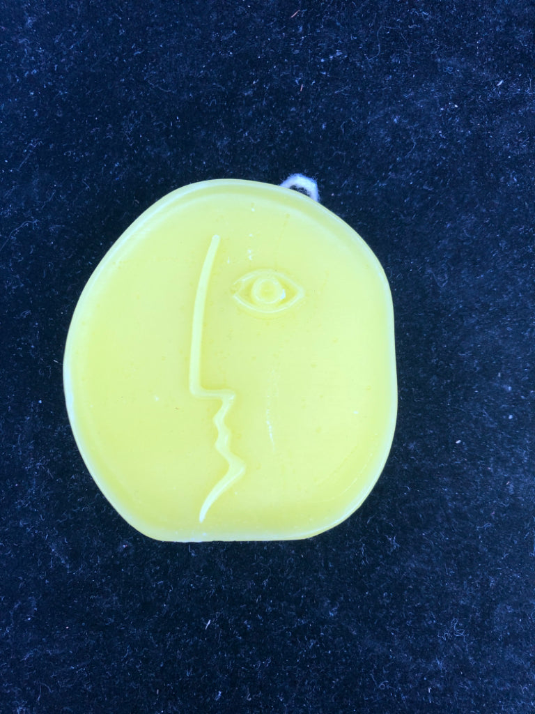 3 ABSTRACT FACE SHAPED CANDLES.