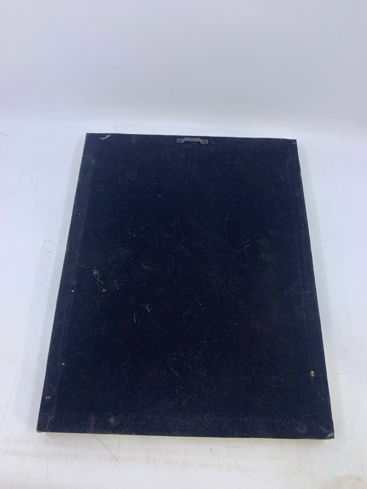 CLOSE UP OF ELVIS LOOKING AT MOTORCYCLE CANVAS.