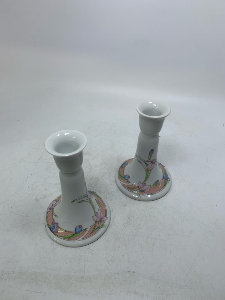 2 FOOTED FLORAL PORCELAIN TAPERED CANDLE HOLDERS.
