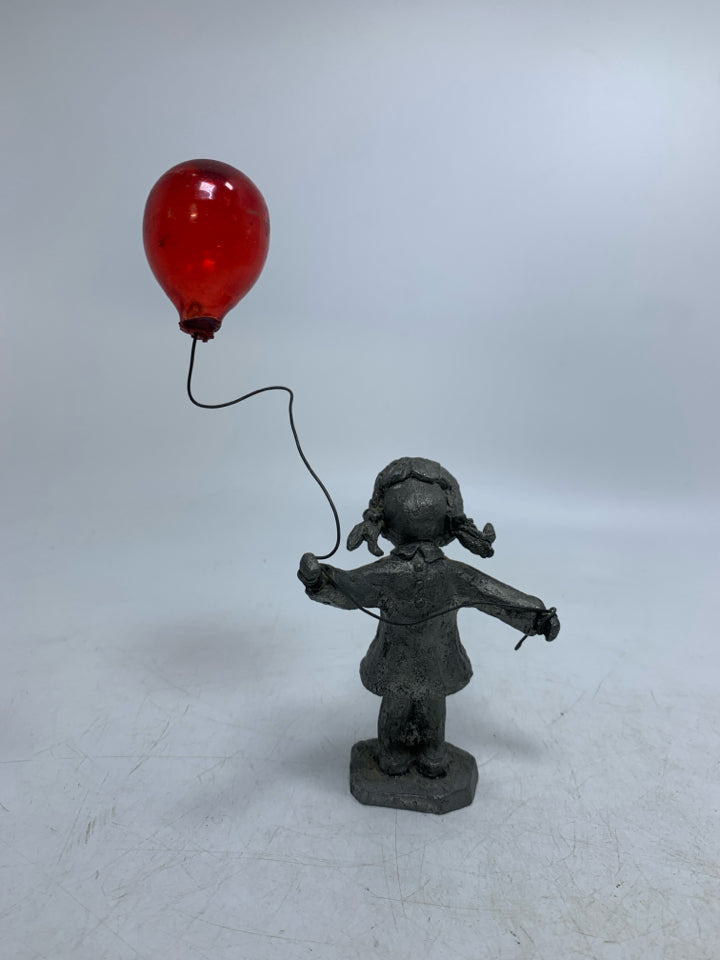 GIRL HOLDING BALLOON FIGURINE.