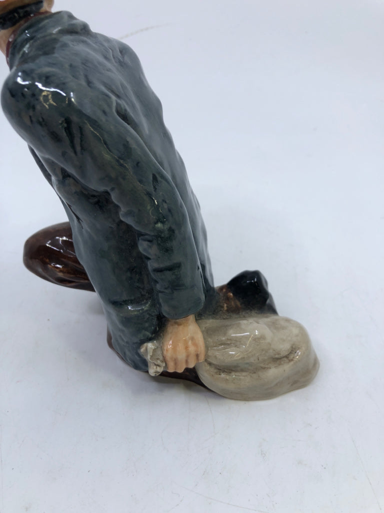 VTG "THE POACHER" KNEELING MAN WITH BLUE COAT AND TAN HAT.
